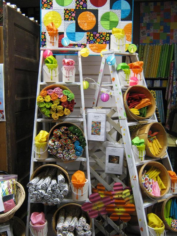 It is a decorative use of vintage ladders for arts and crafts show display, or retail store fixture. 