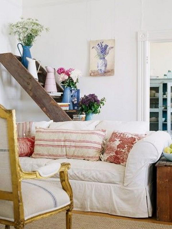 This old ladder was used as a lovely display shelf behind a couch.