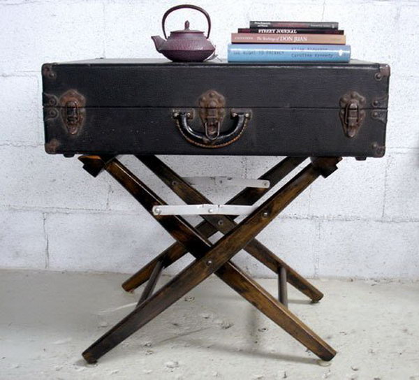 DIY side table made from a damaged canvas folding chair and a vintage suitcase. 