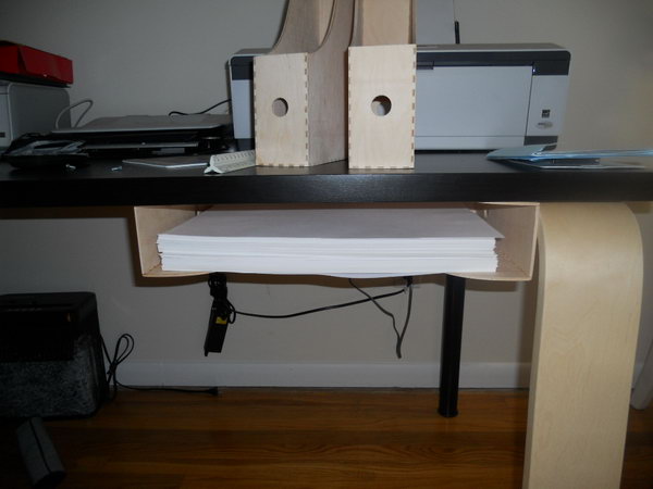 I's cool idea to store those printer paper with the magazine holder under table. 