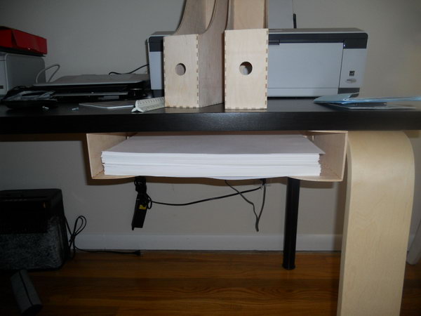 I's cool idea to store those printer paper with the magazine holder under table.  