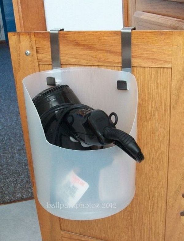 Hair Dryer Holder from Plastic Bottle. Recycle a used bleach bottle as a portable and inexpensive hair dryer caddy. Install it over lower cabinet door. Get the dryer and its clunky cord off your bathroom counter. 