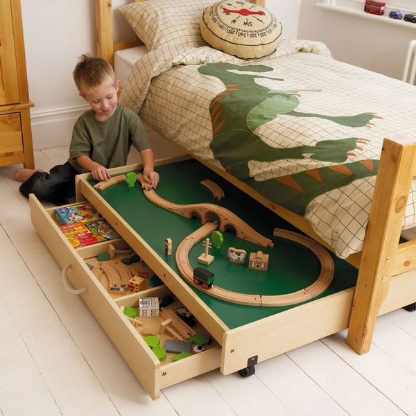 This play table under the bed not only provides a useful play area in your busy bedroom, but also reveals more storage space for toys. 