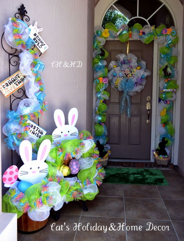 Easter Basket Door Decor. This well refined Easter decor starts with mesh in white and lime green, add the ribbons as the base. Put two baskets filled with treats for children at two sides such as chocolate bunnies, rolled candy, Easter eggs and jelly beans. 