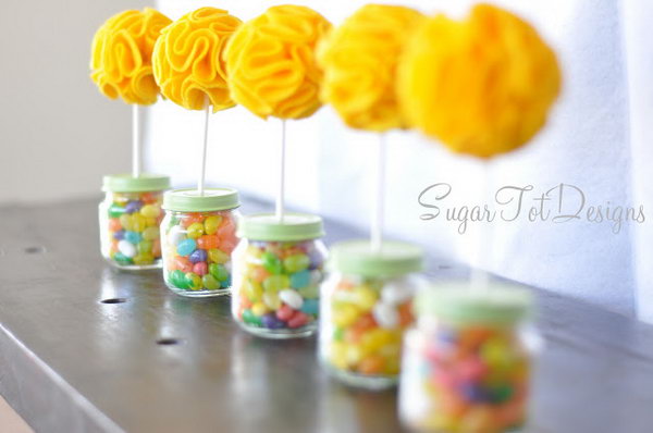 Baby Food Jar Topiary. Fill the baby food jar with colorful jelly beans, insert with a puffy flower topiary to present an exquisite outlook. These adorable things would be great centerpieces for a baby shower. 