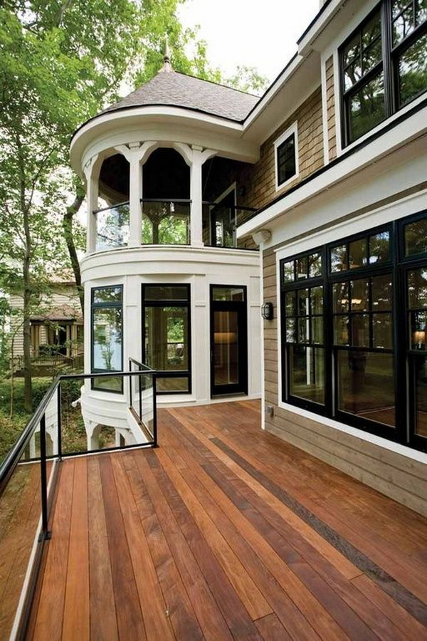 Stay beautiful   Traditional deck with glass deck railing. Adorable gazebo glass system coordinates perfectly with the French doors, double hung windows and the deck.  The glasses allows unobstructed views and they are barriers against the wind. 