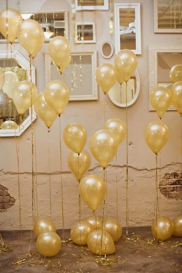Start with the arrangement for the wedding with helium balloons tied golden ribbons and mirrors on the wall in the space. This is super divine. 