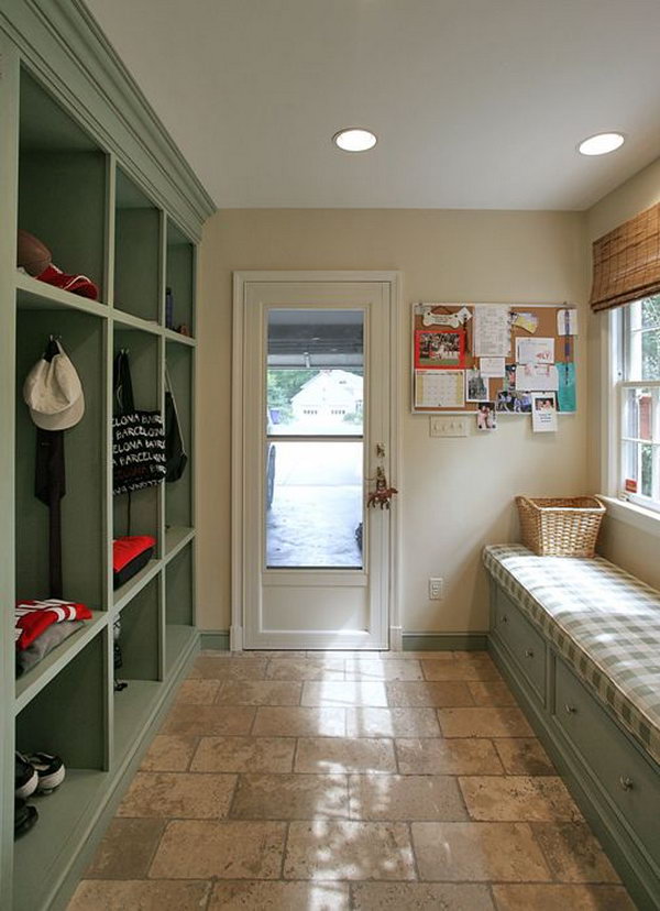 Pastel colored mudroom. Adorable green and cream color layout. This is a great place for the family members to put their shoes coats cats and backpacks. Gray tiles are easy to clean. 