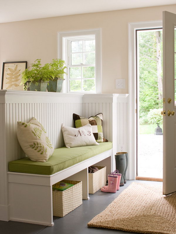 Bright and cozy.  What a fresh, comfortable, and inviting mudroom. Green plants and green bench ecco green trees outdoor. Love the  white wood work.  Really clever room seperation which adds extra function and makes the small space look larger. A neat way to make a foyer. 