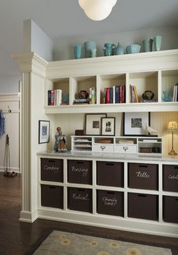 Beautiful mud room. I think this picture is my favorite. The space isn't that big but it so well planned. The cubbies supplies great storage for paper, fabrics and craft supplies. The wood work top lines add traditional feeling to the space. The deep brown baskets , the white trim work and the green wall paint is fresh and lively. 