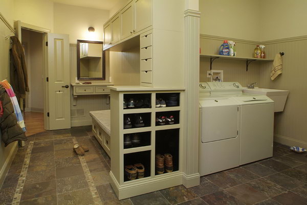 Gray colored mudroom. This nice mudroom gives a place to keep the mud out. With easy to clean floors, plenty of shoe storage below the bench, lots of hooks and even some spacious cabinets, this mudroom is really functional. 