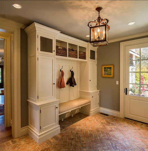 Brick flooring!  Easy to clean brick flooring gives a rustic and durable feel to the space. Every detail is so great. The gray and white color scheme, the lighting, the flooring, the symmetrical cabinet and the wall art. 