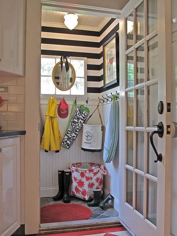  Small neat mudroom. Such a cool tiny mudroom with a great use of the space and every detail in the room is lovely. Like the white door, the panel board wall treatment. And the black hooks, stripe wallpaper, big handle add stylish to the space. Usually, mudrooms are dirty and scuffed and full of old, rotting rain jackets and boots. But this one is incredibly neat.