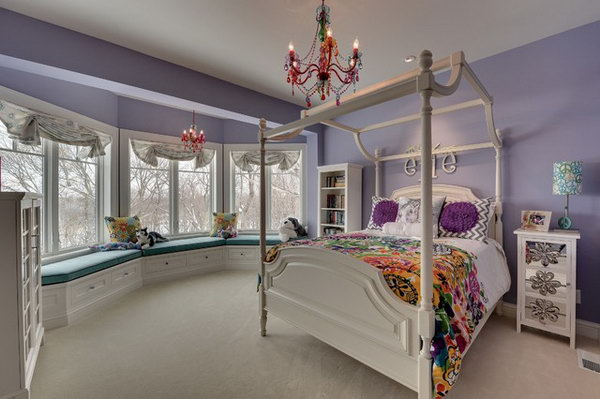 In this bedroom, the color layout of lavender and white with a little green to cheer up features a very feminine and peaceful girl's bedroom. The canopy bed, the arched window treatment and hanging chandelier make the room magical for a child. 