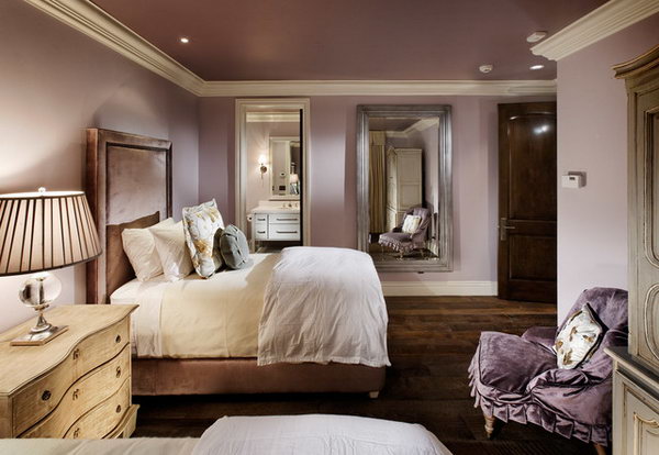 Mirror on the wall: In this bedroom, the dark, rustic flooring and door contrasts with the lighter tones of the contemporary bed and chair. Painting the ceiling the same color creates a cozy and intimate space, keeping the moldings white helps brighten the space. Loving the mirrors on the wall which keep the space from dark.