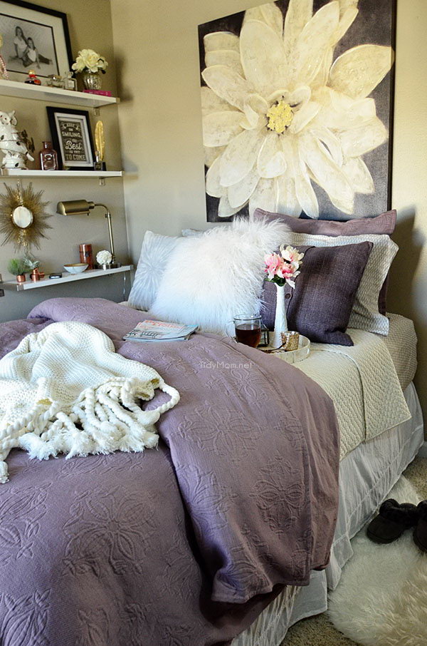 Purple Wall Art: The oversized wall art and curtains used in this bedroom is a tricky way to accent the pastel feel of this bedroom. 