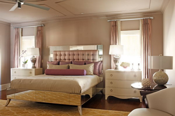 Mauve Master Bedroom: The color Mauve is used through out the space and transcends the word glamour to create a truly masterful retreat which  matches the drapery and bed upholstery.  The custom bed with a luxury headboard is the show piece that anchors the two ivory lacquered chest. 