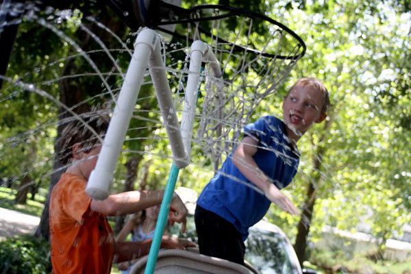  PVC pipes. Take a few PVC pipes and random connectors and make  holes drilled in random spots.  Connect the garden hose shoved in one end and then open the floodgates. 