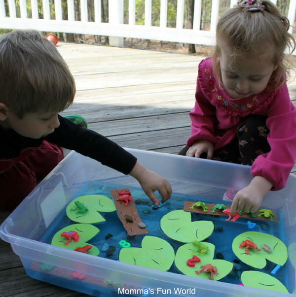 Frog sensory play and math learning game. This sensory bin is a great way for your kids to explore with their little hands. The lily pads and the logs are cut out of craft foam and then use a sharpie marker to make the lines. 
