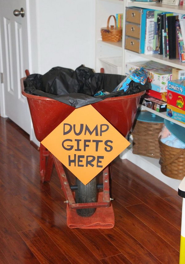 Construction Birthday Party Decoration: Add a black tablecloth for decoration and my fun dump gifts here sign to a wheel barrow and put all the gifts inside for decoration. 