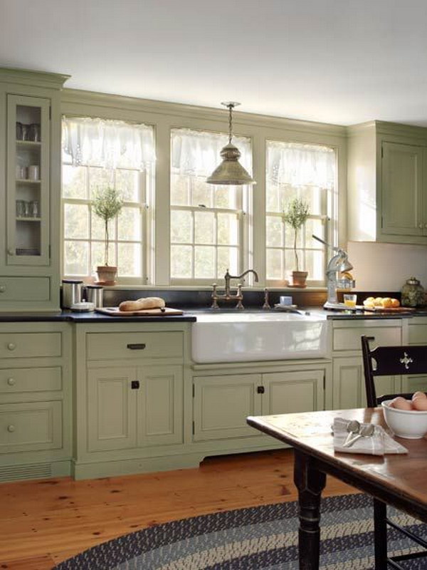 Grey green Cabinets Paired with Apron Sink and Double Hung Windows. 